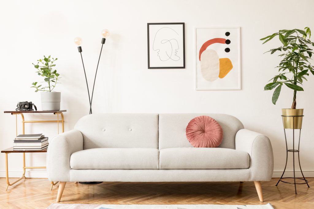 Retro and vintage interior of living room with design grey sofa,